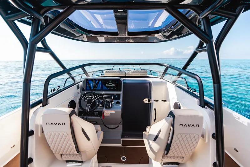 Slide: The Image of Interior view of 2025 Navan S30 boat, featuring modern dashboard and ocean backdrop. - 1
