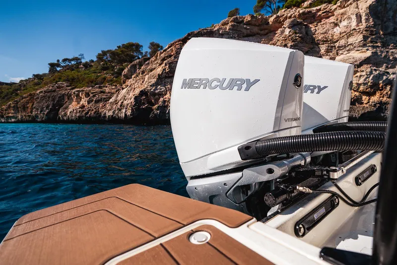 Slide: The Image of 2025 Navan S30 boat with Mercury outboard engines near rocky coastline. - 16