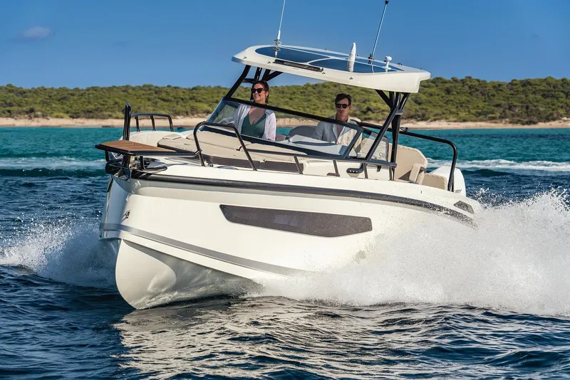 Slide: The Image of Navan S30 2025 boat cruising on open water, two people onboard, clear sky. - 24