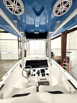 Slide: The Image of 2025 Tidewater 198 CC Adventure boat interior with blue canopy and modern controls. - 6