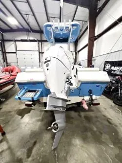 Slide: The Image of 2025 Tidewater 198 CC Adventure boat in a garage, showcasing its outboard motor. - 7
