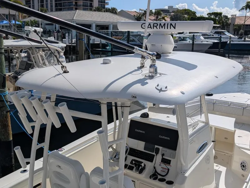 Slide: The Image of 2023 Cobia 301 Center Console boat with Garmin radar, docked at marina. - 11