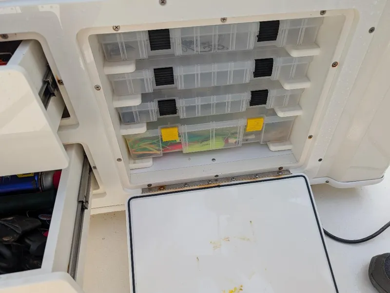 Slide: The Image of 2023 Cobia 301 Center Console boat interior with rod holder and dashboard. - 21