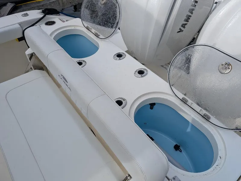Slide: The Image of Storage drawers on a 2023 Cobia 301 Center Console boat, containing fishing gear and tools. - 22