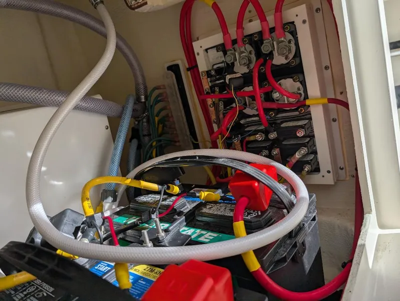 Slide: The Image of Battery and wiring system inside a 2023 Cobia 301 Center Console boat. - 25