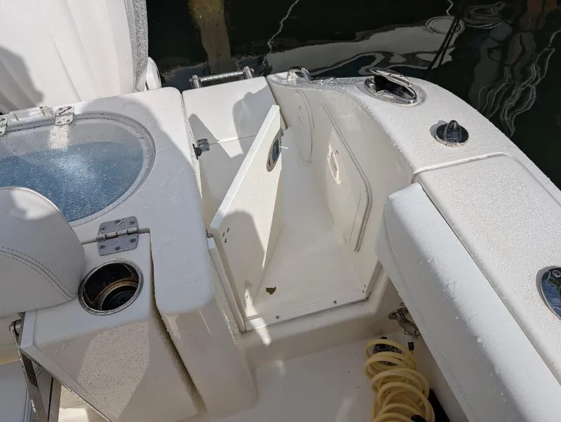 Slide: The Image of 2023 Cobia 301 Center Console boat interior detail with yellow fitting and black rope. - 32