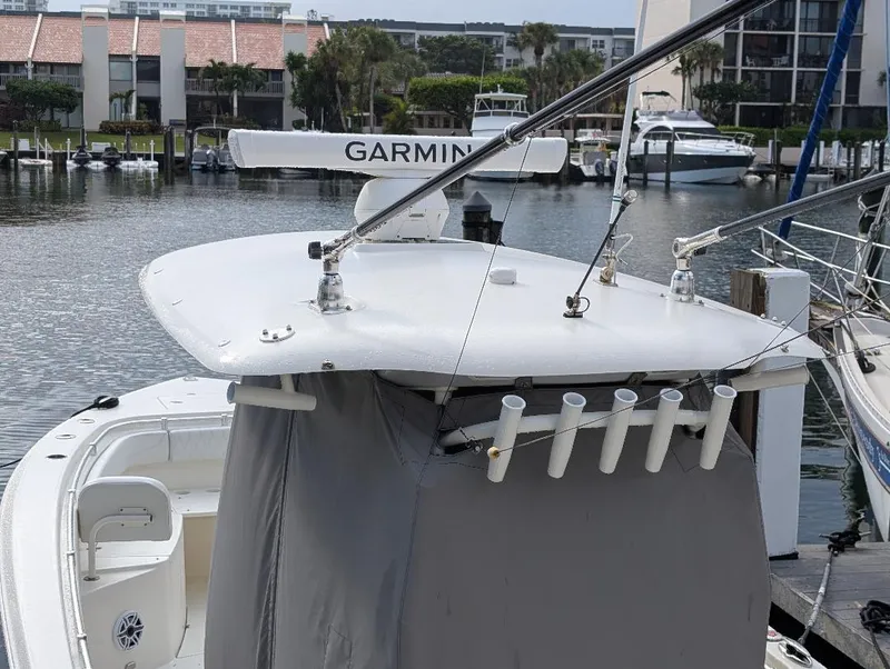 Slide: The Image of 2023 Cobia 301 Center Console boat with Garmin navigation system, docked at marina. - 34