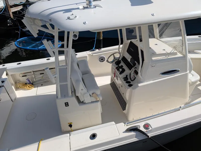 Slide: The Image of 2023 Cobia 301 Center Console boat with spacious deck and modern controls. - 6