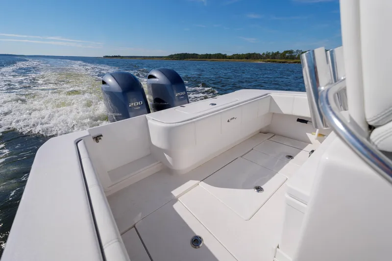 Slide: The Image of 2022 Contender 25 boat with dual engines cruising on open water. - 11