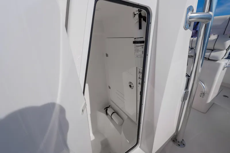 Slide: The Image of 2022 Contender 25 boat storage compartment with open door. - 12