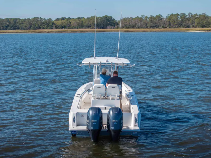 Slide: The Image of 2022 Contender 25 boat with dual engines on a calm lake. - 17