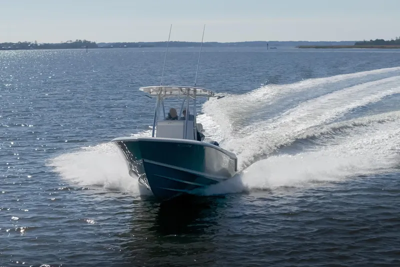 Slide: The Image of 2022 Contender 25 boat cruising on open water, creating a dynamic wake. - 3