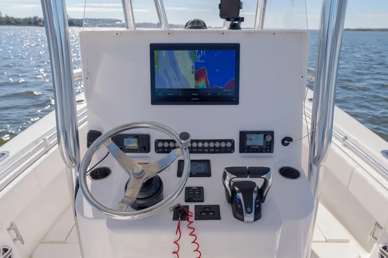 Slide: The Image of Center console of 2022 Contender 25 boat with navigation equipment and steering wheel. - 4