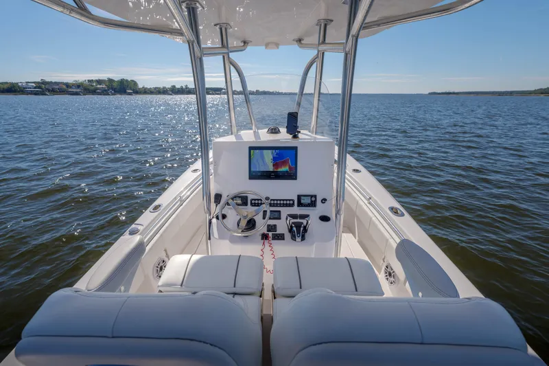 Slide: The Image of 2022 Contender 25 boat interior with navigation system on open water. - 5