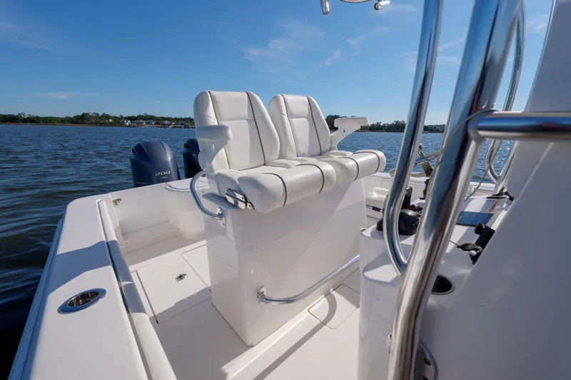 Slide: The Image of 2022 Contender 25 boat interior with white seating, on calm water. - 6