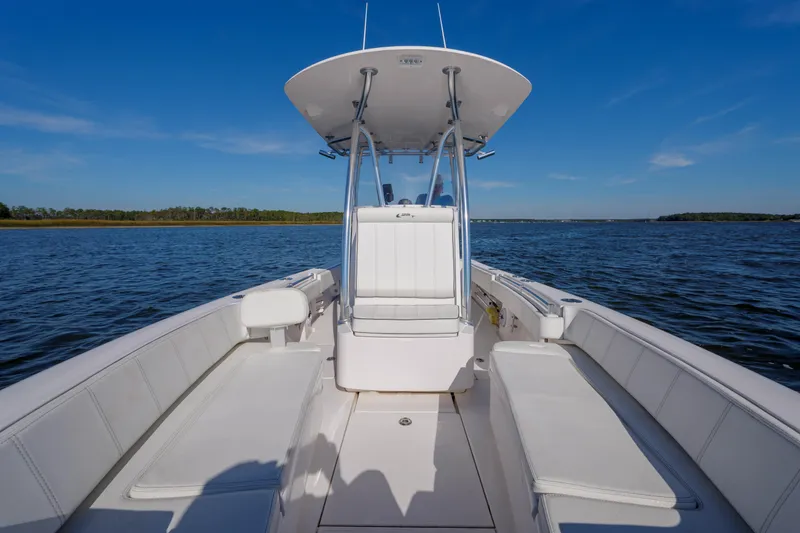 Slide: The Image of 2022 Contender 25 boat on open water, featuring spacious seating and sleek design. - 8