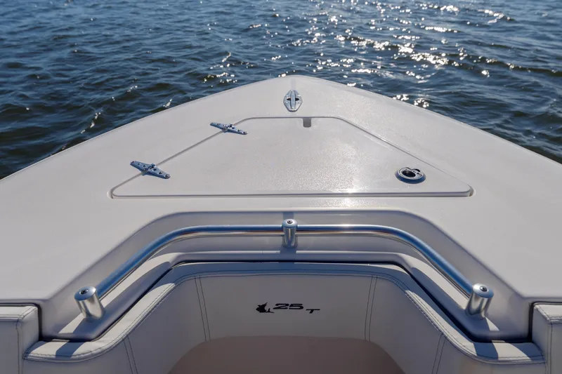 Slide: The Image of 2022 Contender 25 boat bow on water, showcasing sleek design and craftsmanship. - 9