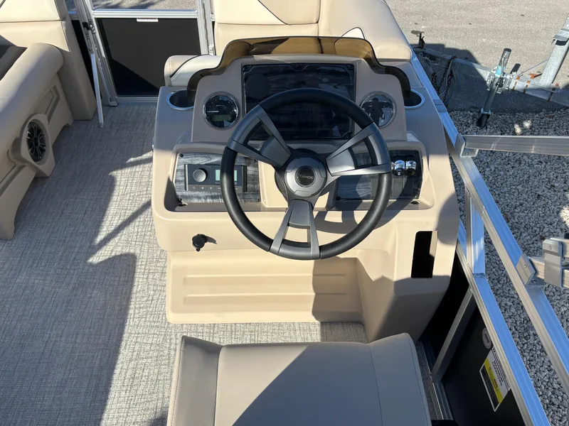 Slide: The Image of 2025 Tahoe Pontoon 15 Sport interior with gray, white, and blue seating and speaker system. - 5