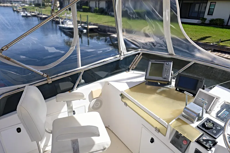 Slide: The Image of Flybridge helm of 2000 Legacy Downeast boat with navigation equipment and waterfront view. - 22