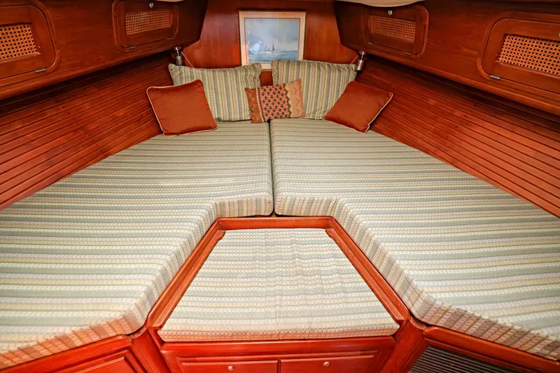 Slide: The Image of Interior of 2000 Legacy Flybridge Downeast boat with cozy striped bedding and wooden finish. - 37