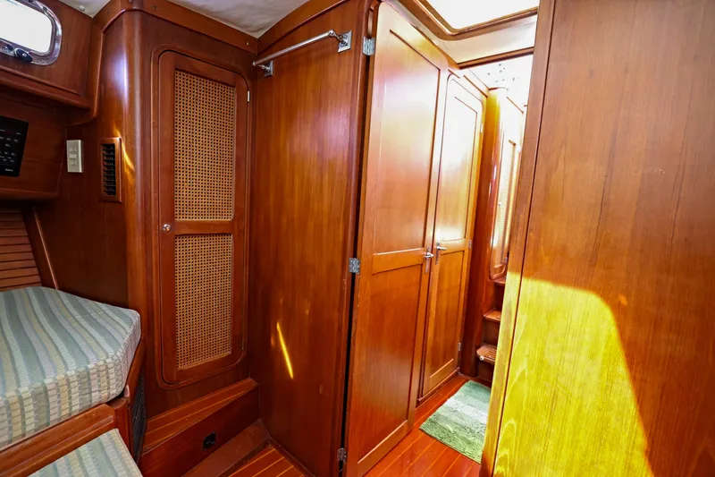 Slide: The Image of Interior of 2000 Legacy Flybridge Downeast boat with wooden cabinetry and cozy sleeping area. - 41