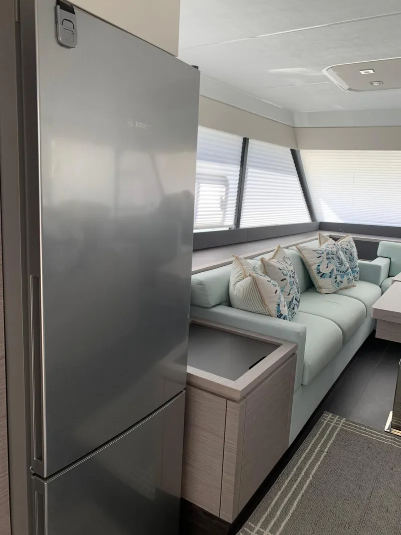 Slide: The Image of 2024 Fountaine Pajot MY5 yacht interior with modern kitchen and stylish seating area. - 2