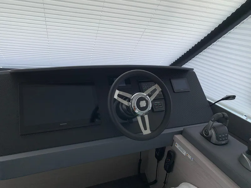 Slide: The Image of 2024 Fountaine Pajot MY5 helm with modern steering wheel and navigation controls. - 4