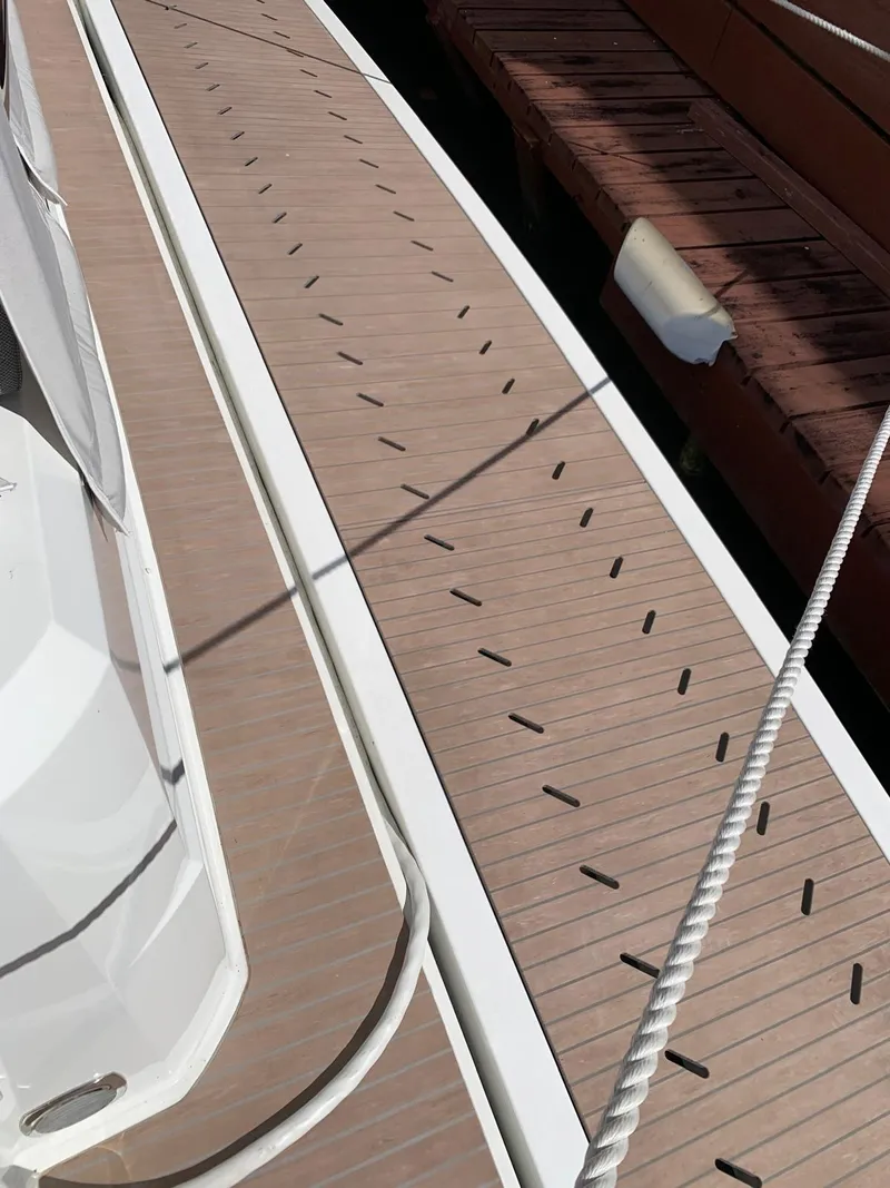 Slide: The Image of 2024 Fountaine Pajot MY5 yacht deck with modern design and wood finish. - 6