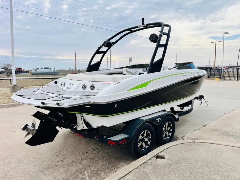 Slide: The Image of 2018 Tahoe 700 Limited boat on trailer, sleek design with green accents. - 2