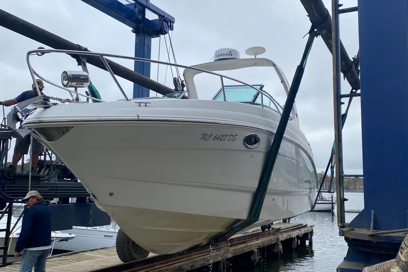 Slide: The Image of 2011 Chaparral 270 Signature on a boat lift by the water. - 22
