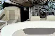 Slide: The Image of Interior of a 2011 Chaparral 270 Signature boat with steering wheel and seats. - 25