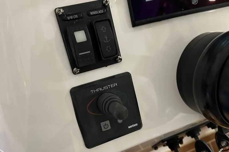 Slide: The Image of Control panel of a 2017 Intrepid 430 Sport Yacht featuring thruster and windlass switches. - 12