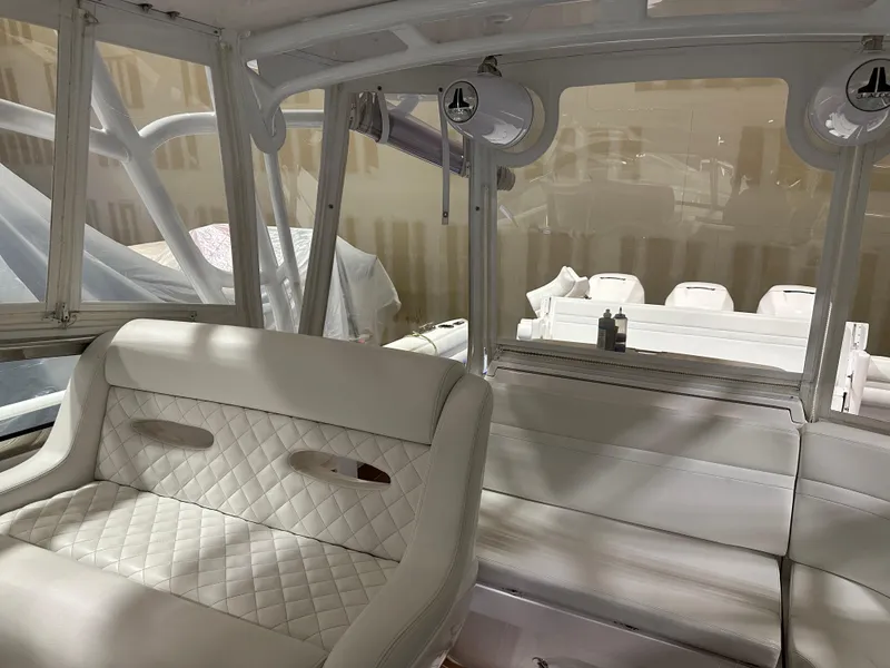 Slide: The Image of Interior of a 2017 Intrepid 430 Sport Yacht with white quilted seating. - 13