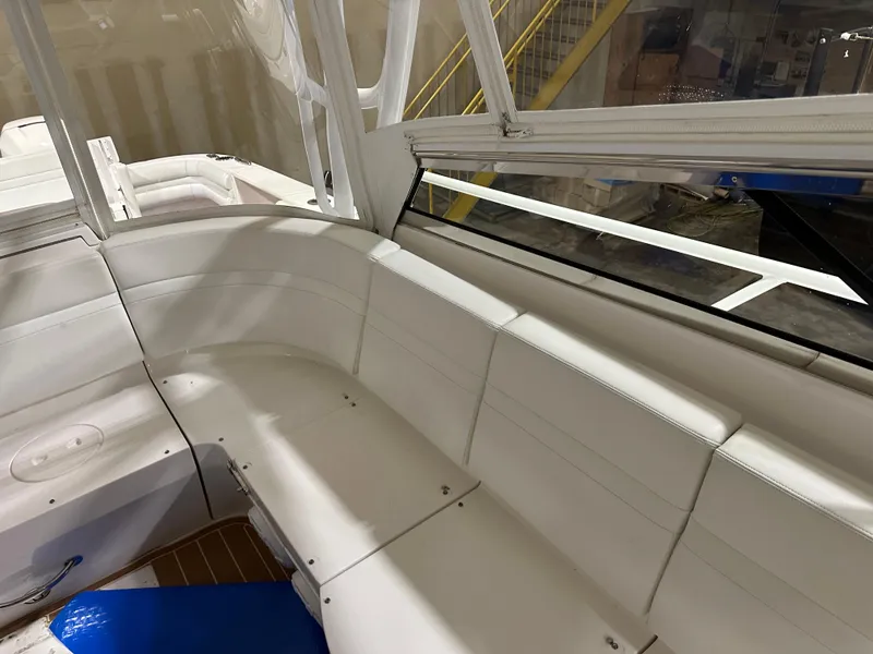 Slide: The Image of 2017 Intrepid 430 Sport Yacht interior with white seating and large windows. - 15