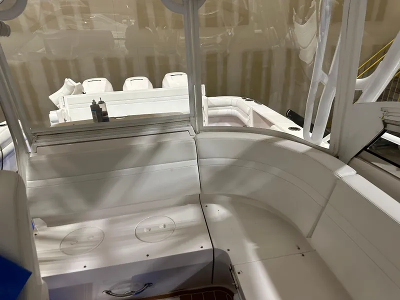 Slide: The Image of 2017 Intrepid 430 Sport Yacht interior with white seating and sleek design. - 16
