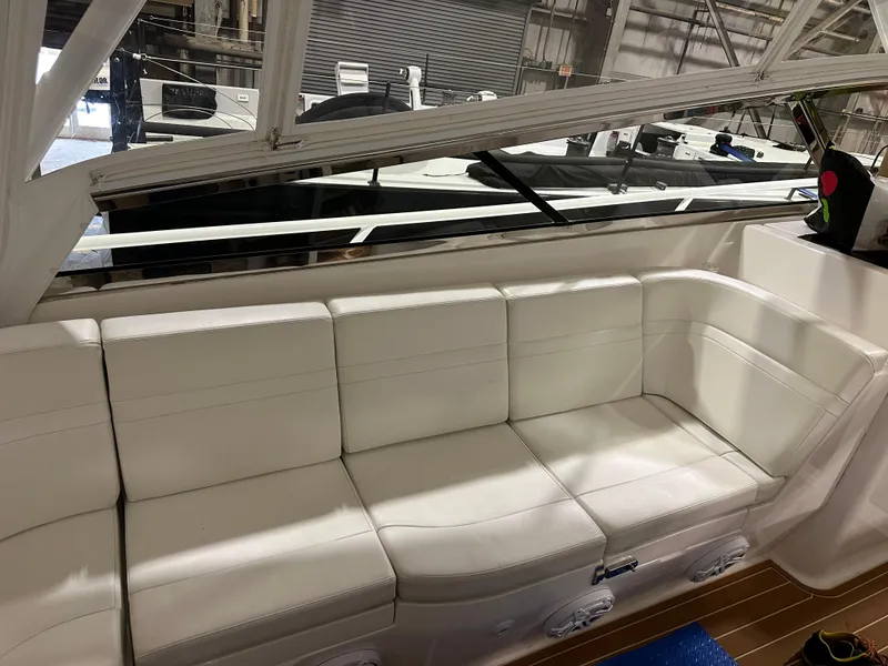 Slide: The Image of 2017 Intrepid 430 Sport Yacht interior with white leather seating and sleek design. - 17