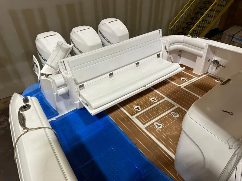 Slide: The Image of 2017 Intrepid 430 Sport Yacht with white seating and teak flooring, featuring triple outboard engines. - 18