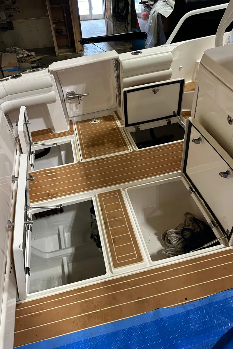 Slide: The Image of 2017 Intrepid 430 Sport Yacht with open storage compartments and teak flooring. - 19
