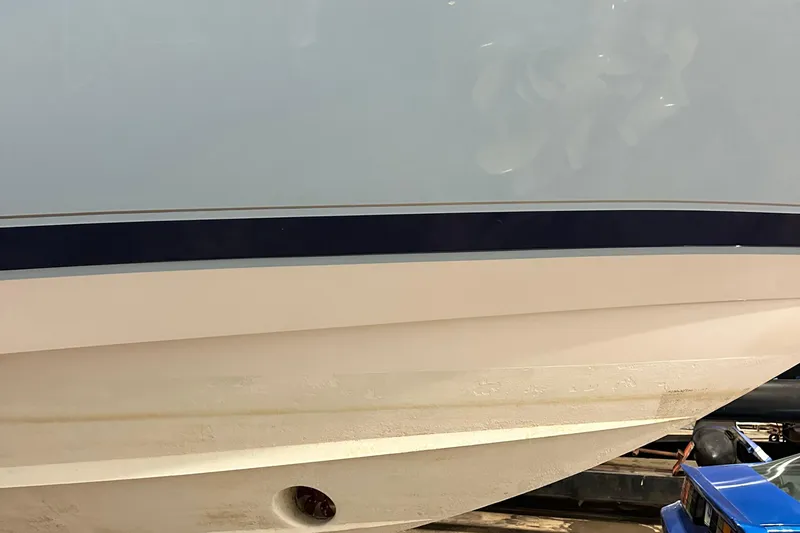 Slide: The Image of 2017 Intrepid 430 Sport Yacht hull with sleek design and blue stripe detail. - 2