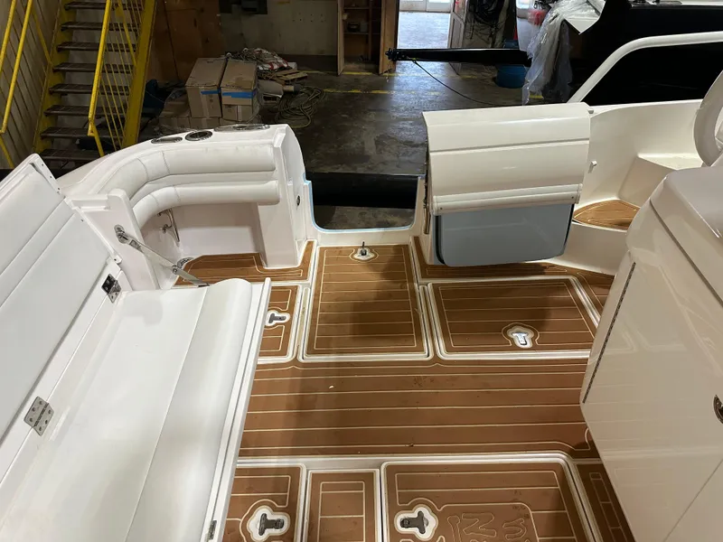 Slide: The Image of 2017 Intrepid 430 Sport Yacht interior with teak flooring and white seating. - 21