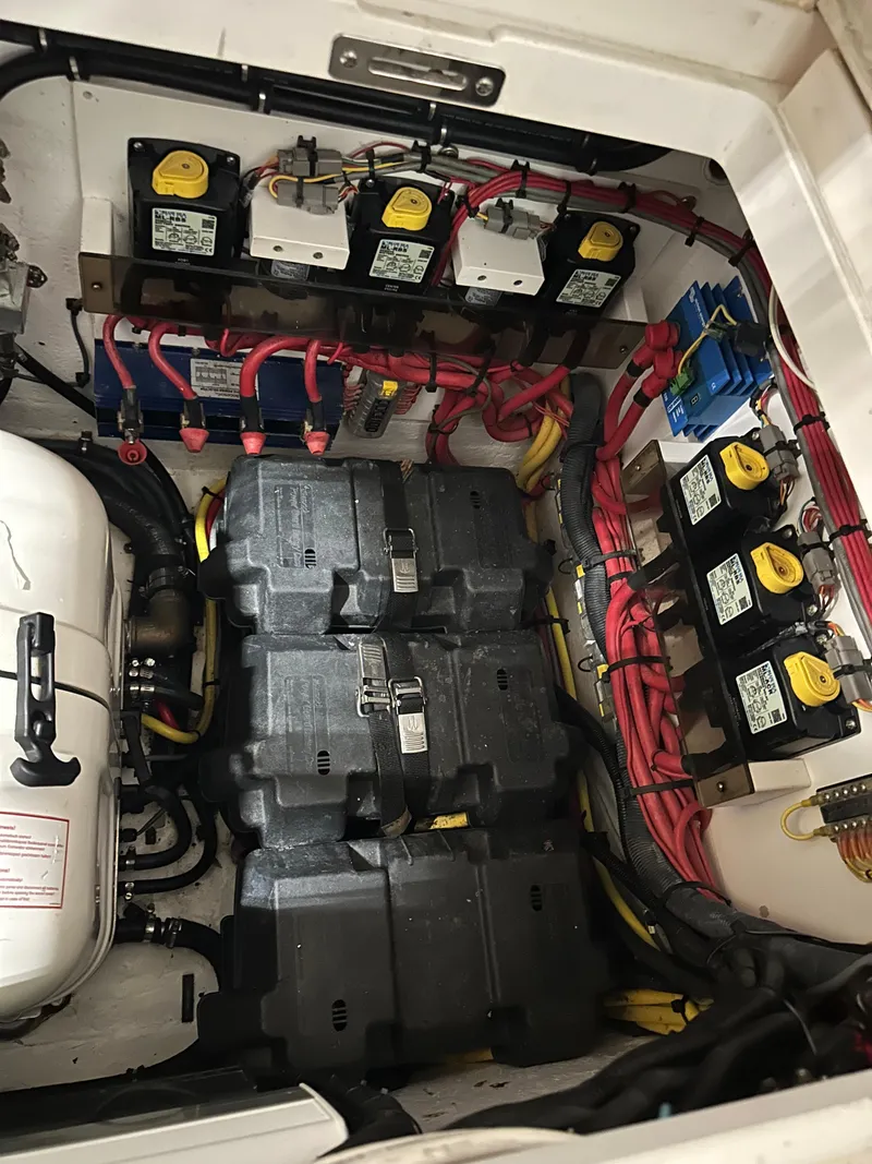 Slide: The Image of Engine room of a 2017 Intrepid 430 Sport Yacht with batteries and wiring. - 29