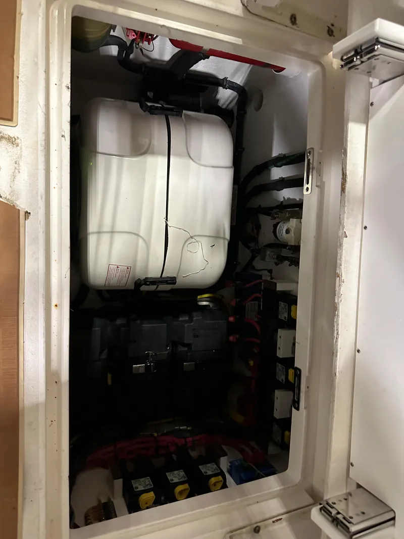 Slide: The Image of Engine compartment of a 2017 Intrepid 430 Sport Yacht, showcasing internal components and wiring. - 31