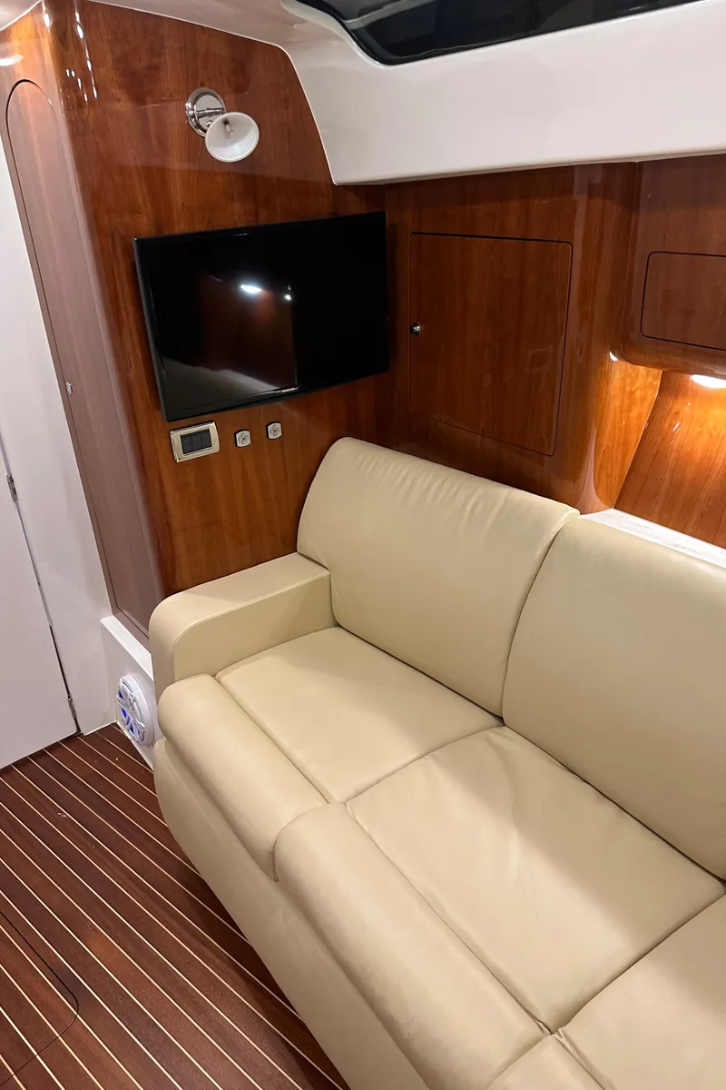 Slide: The Image of Luxurious interior of 2017 Intrepid 430 Sport Yacht with beige sofa and wooden accents. - 36