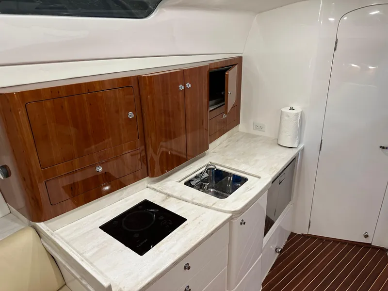 Slide: The Image of 2017 Intrepid 430 Sport Yacht kitchen with sleek cabinetry and modern appliances. - 37