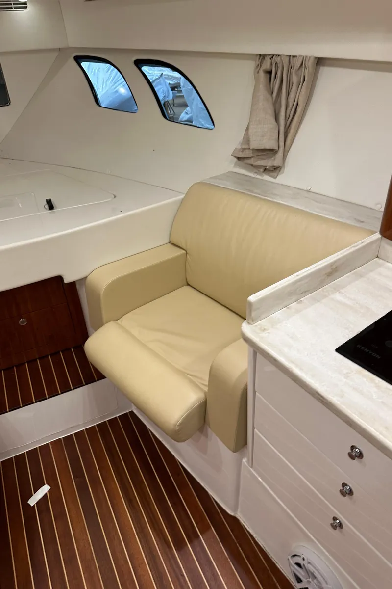 Slide: The Image of Interior of 2017 Intrepid 430 Sport Yacht with beige seating and wood flooring. - 39