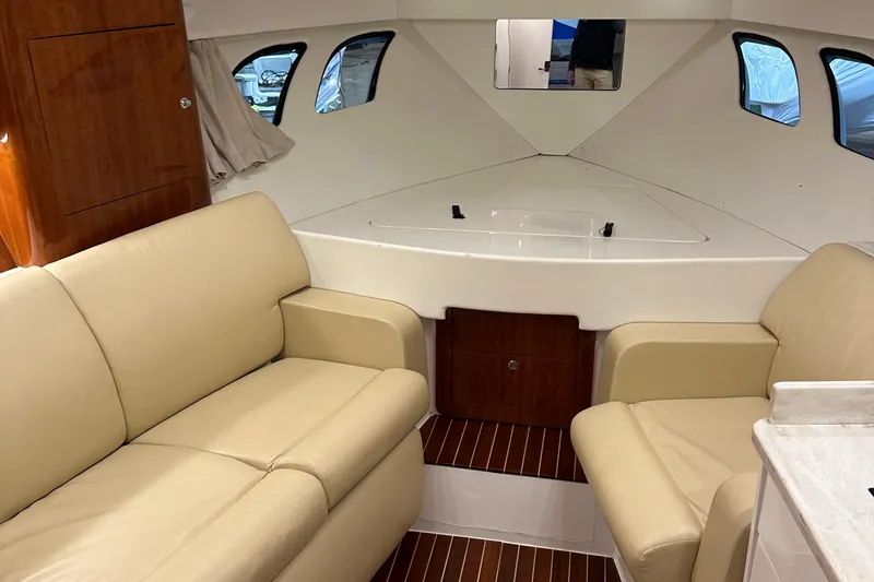 Slide: The Image of Interior of 2017 Intrepid 430 Sport Yacht with beige seating and wooden accents. - 40