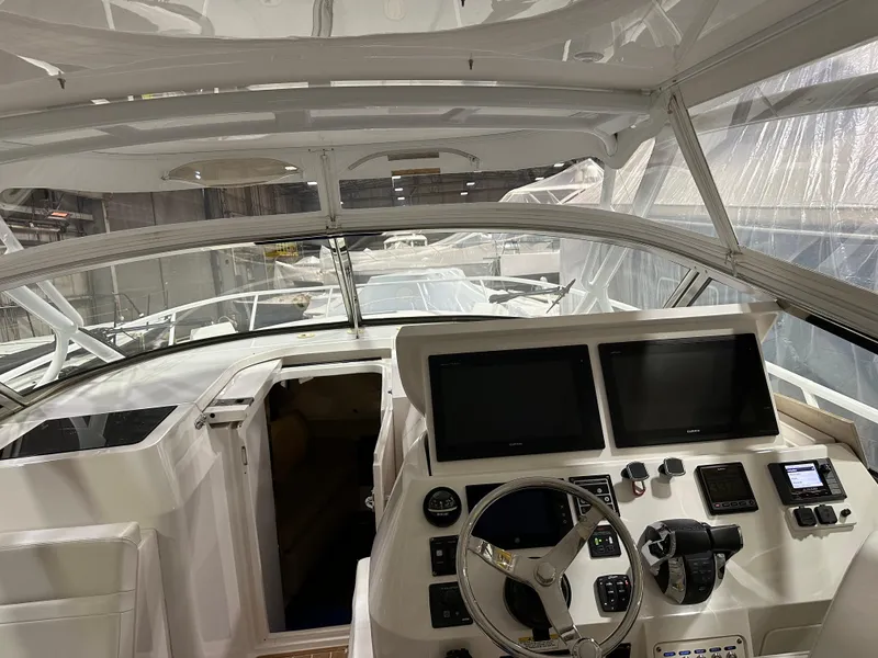 Slide: The Image of 2017 Intrepid 430 Sport Yacht cockpit with dual screens and steering wheel. - 5