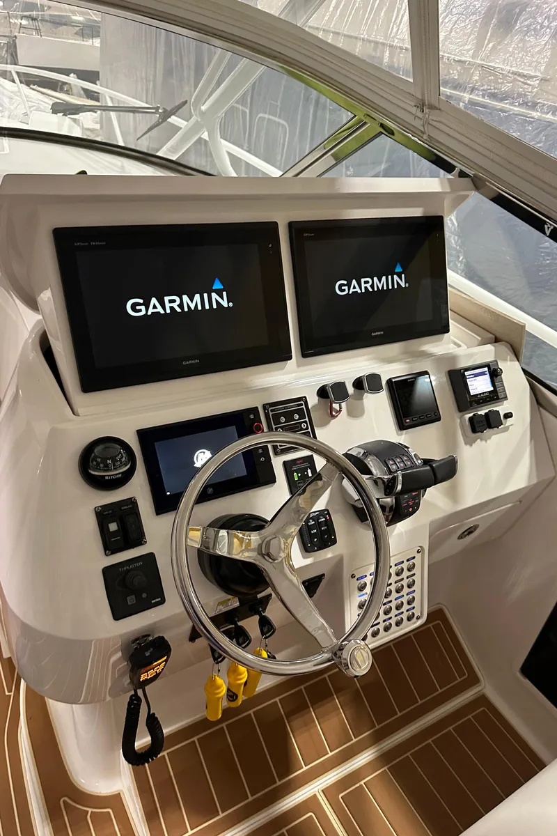 Slide: The Image of Intrepid 430 Sport Yacht 2017 helm with Garmin displays and modern controls. - 7