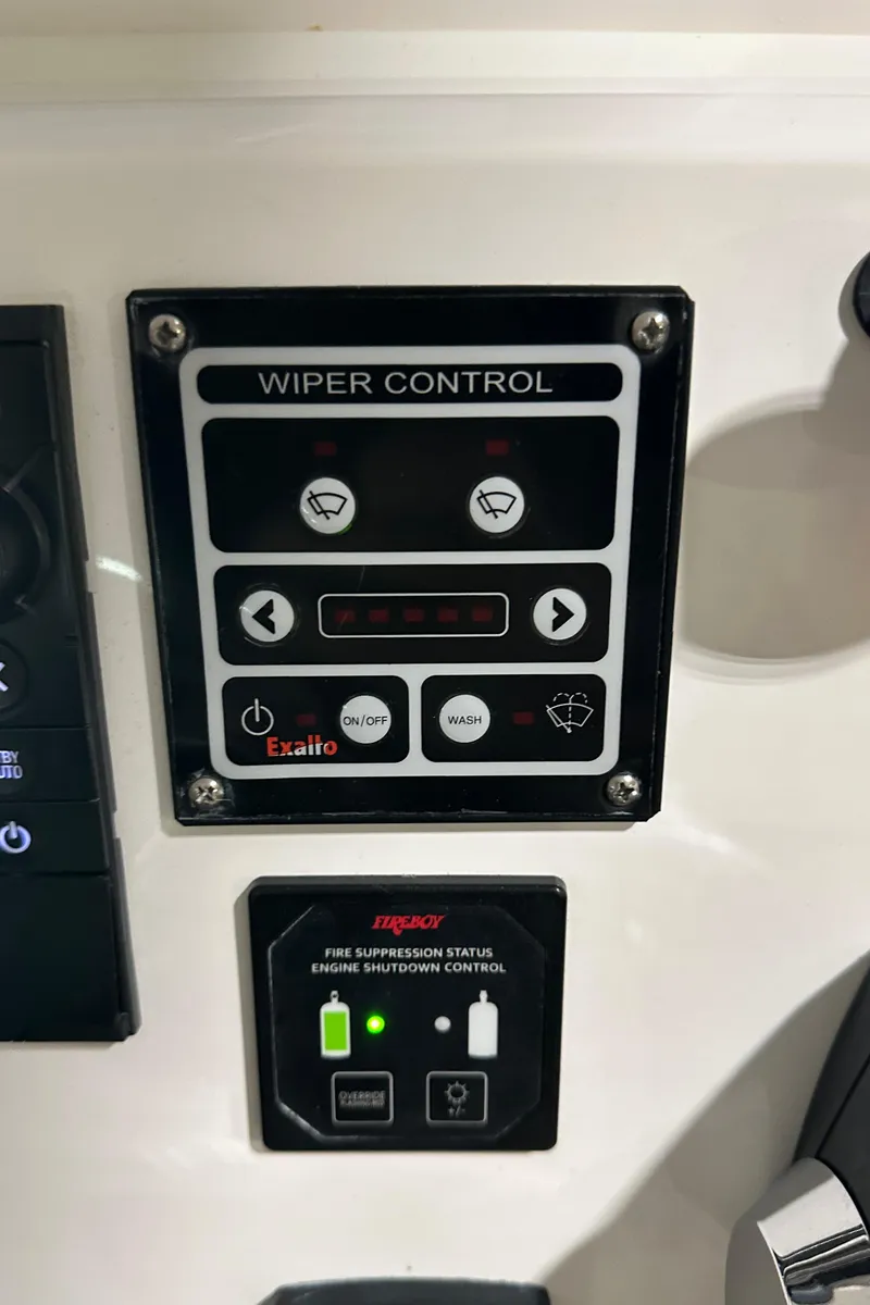 Slide: The Image of Wiper and fire suppression controls on a 2017 Intrepid 430 Sport Yacht dashboard. - 8