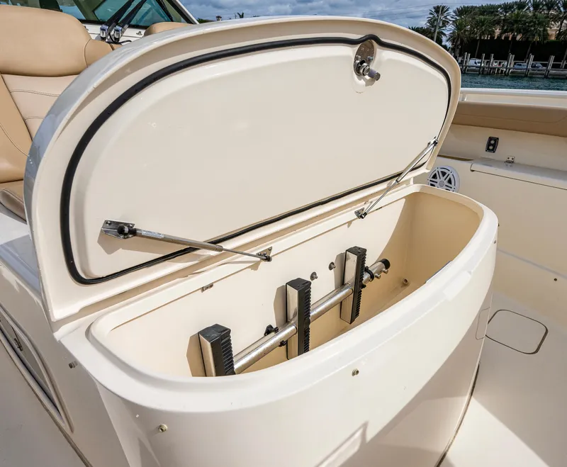 Slide: The Image of 2019 Scout 420 LXF boat storage compartment open, showcasing interior features. - 11
